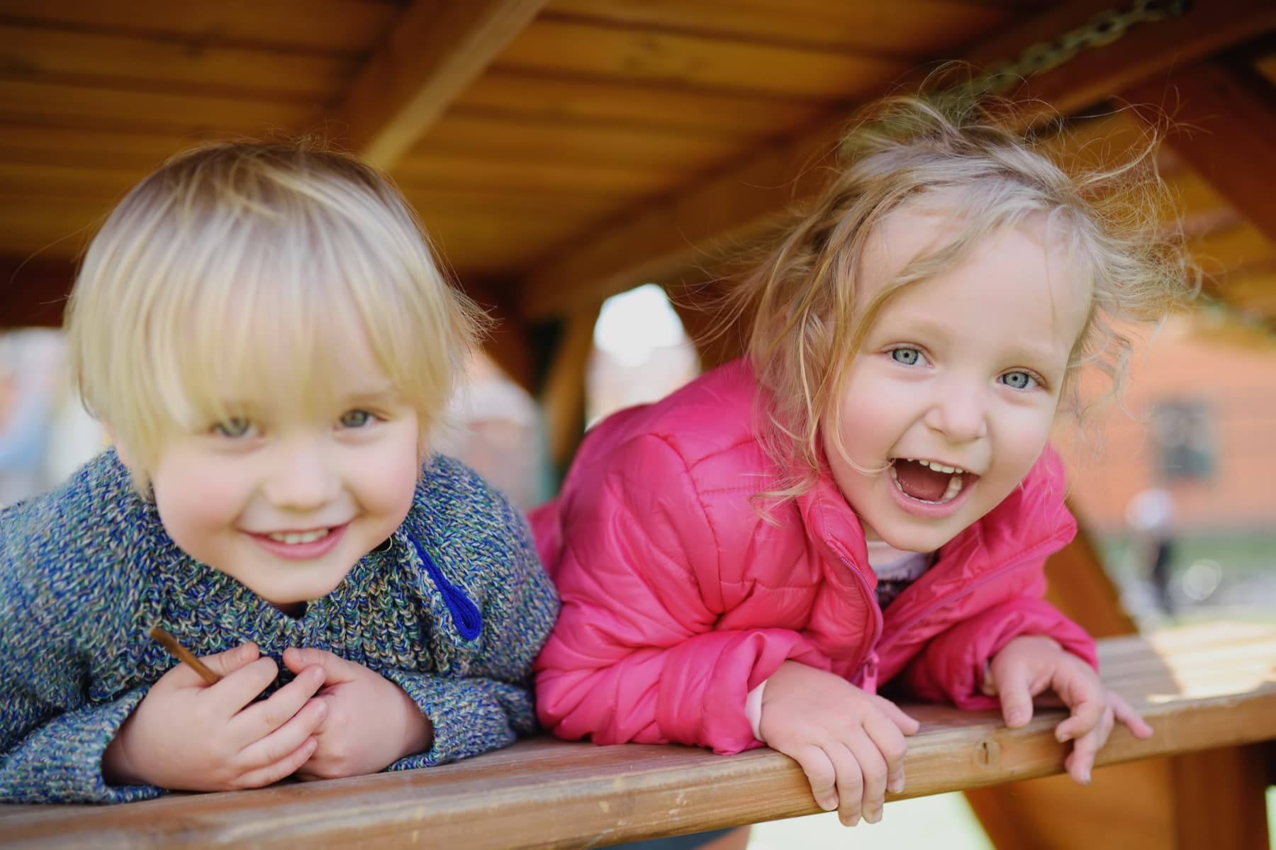 Trygge barn som leker ute sammen med en barnepasser